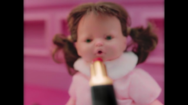 Video Reference: Child, Face, Hair, Facial expression, Pink, Cheek, Toddler, Head, Nose, Baby, Person, Indoor, Little, Small, Food, Eating, Holding, Sitting, Toy, Piece, Front, Young, Table, Mouth, Cake, Boy, Girl, Black, Plate, Brush, White, Bear, Standing, Sandwich, Stuffed, Pizza, Human face, Toothbrush