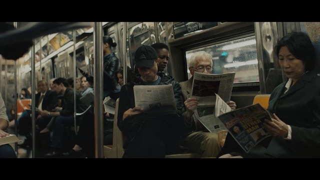 Video Reference: Snapshot, Mode of transport, Human, Conversation, Passenger, Adaptation, Screenshot, Photography, Movie, Scene, Person, Indoor, Man, People, Looking, Sitting, Woman, Group, Photo, Bus, Train, Standing, Table, Food, Young, Restaurant, Room, Phone, Text, Clothing, Human face, Crowd