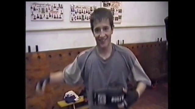 Video Reference: Photograph, Arm, Snapshot, Music, T-shirt, Muscle, Photography, Hand, Sitting, Guitarist, Person, Man, Indoor, Standing, Front, Young, Boy, Holding, Shirt, Posing, Wearing, Suitcase, Room, Black, Remote, Luggage, Table, Video, Television, Woman, Playing, Kitchen, Clothing, Text, Human face, Smile