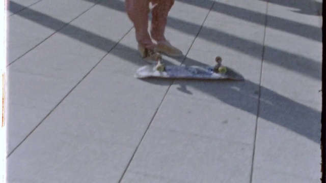 Video Reference: Floor, Tile, Sidewalk, Snapshot, Road surface, Flooring, Footwear, Skateboard, Asphalt, Skateboarding Equipment