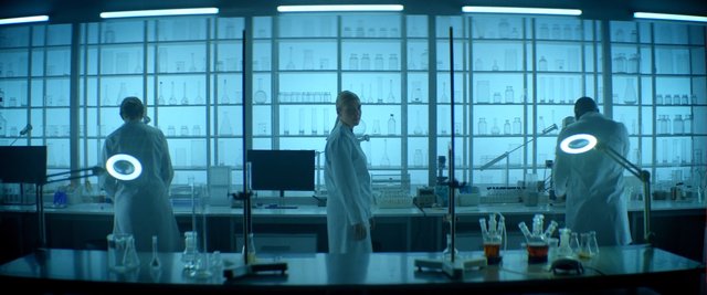 Video Reference: laboratory, lab coats, scientists, research, glassware, workbench, medical, science, experiment, indoor, blue lighting, clean room, equipment, analysis, biotech