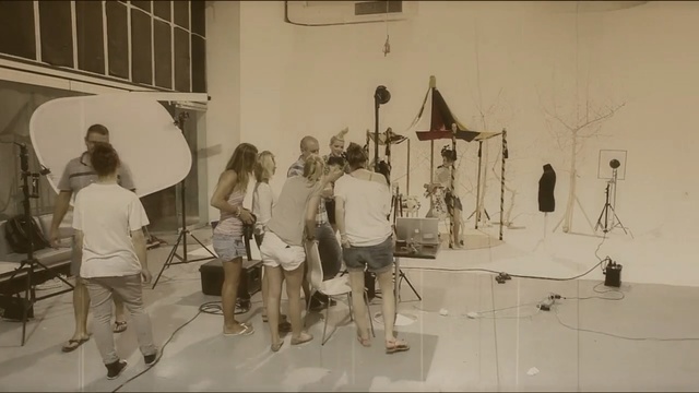 Video Reference: Black-and-white, Visual arts, Art, Style, Indoor, Man, Photo, Table, Room, Woman, Group, People, Standing, Mirror, White, Young, Holding, Playing, Kitchen, Video, Wall, Person, Clothing, Footwear