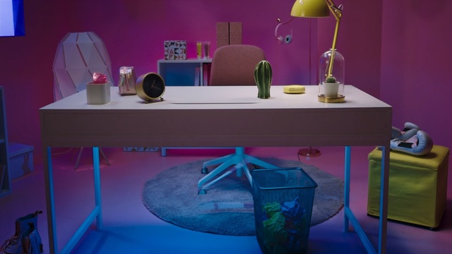 Video Reference: blue, furniture, purple, table, room, desk, light, interior design, shelf, product, Person