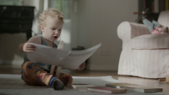 Video Reference: child, room, toddler, sitting, furniture, infant, wood, play, girl, table, Person