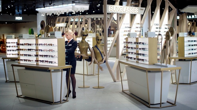 Video Reference: Product, Eyewear, Inventory, Building, Vision care, Glasses, Person, Floor, Indoor, Table, Chair, Sitting, Library, Kitchen, Computer, Desk, Laptop, Room, Front, Office, Food, Small, White, Dining, Black, Man, Woman, Standing, Eating, Large, Holding, Store, People, Bed, Dog, Luggage, Group, Plate, Bedroom, Clothing, Furniture, Shelf, Footwear, Text, Art