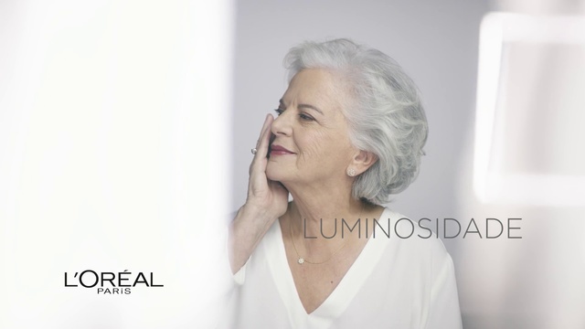 Video Reference: Face, Hair, Skin, Nose, Head, Chin, Beauty, Eyebrow, Cheek, Hairstyle, Person, Indoor, Woman, Clothing, Man, Holding, Looking, Front, Shirt, Lady, Dress, Young, Posing, Wearing, White, Standing, Smiling, Underwear, Mirror, Cake, Wedding, Cut, Phone, Remote, Room, Wall, Human face, Fashion accessory, Necklace, Portrait, Lipstick, Neck, Earrings