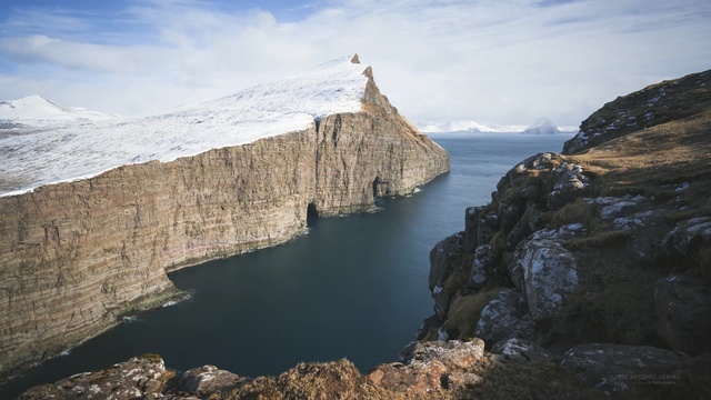 Video Reference: cliff, rock, sky, mountain, terrain, coast, formation, promontory, escarpment, fjord