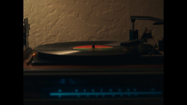 Video Reference: Electronics, Darkness, Lighting, Gramophone record, Technology, Font, Photography, Publication, Space, Electronic device, Indoor, Sitting, Table, Computer, Black, Front, Small, Laptop, Light, Room, Kitchen, Monitor, Counter, Desk, Lit, White, Television, Man, Oven, Standing, Cat, Screenshot, Text