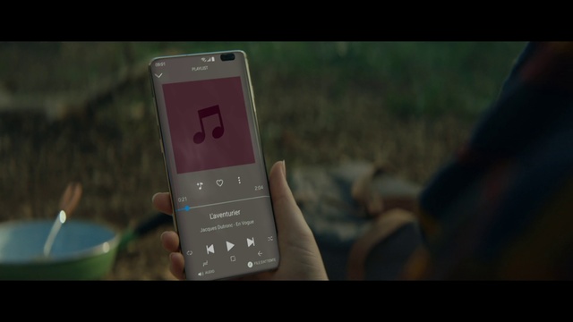 Video Reference: Gadget, Feature phone, Electronic device, Communication device, Technology, Text, Mobile phone, Portable communications device, Electronics, Screenshot, Indoor, Sitting, Holding, Small, Cellphone, Hand, Table, Photo, Computer, Phone, Screen, Front, Monitor, Remote, Laptop, Close, Keyboard, Man, Red, Desk, Video, White, Smartphone