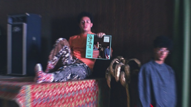 Video Reference: Performance, Event, Performing arts, Fun, Talent show, Adaptation, Singing, Stage, Music, Musician, Person, Man, Young, Holding, Table, Room, Phone, Woman, Boy, Shirt, Standing, People, Computer, Living, Blue, Playing, Clothing, Human face, Book