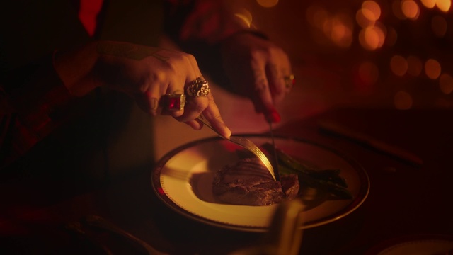 Video Reference: Food, Hand, Dish, Cuisine, Flesh, Comfort food, Person, Indoor, Table, Cake, Cutting, Sitting, Piece, Knife, Plate, Cut, Holding, Woman, Fork, Man, Pizza, Eating, Red, White, Kitchen, Standing