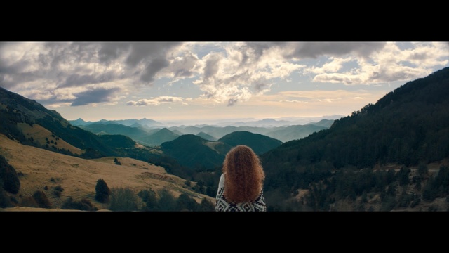 Video Reference: Mountainous landforms, Nature, Sky, Mountain, Highland, Wilderness, Hill, Cloud, Atmospheric phenomenon, Tree, Outdoor, Photo, Background, Clouds, View, Cloudy, Standing, Field, Sheep, White, Side, Large, Rocky, Grazing, Snow, Grassy, Horse, Herd, Flying, Man, Hillside