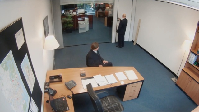 Video Reference: Floor, Office, Flooring, Room, Table, Furniture, Architecture, Desk, Interior design, Tourist attraction, Person