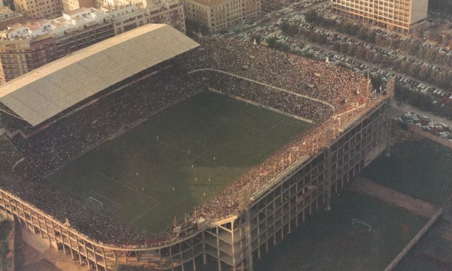 Video Reference: Sport venue, Stadium, Arena, Architecture, Aerial photography, Building, Metal, Sitting, Table, Train, Counter, Large, Tiled, Brick, Covered, City, Bridge, Track, Bench, White, Standing, Room, Sink, Street, Luggage, Double, Aerial