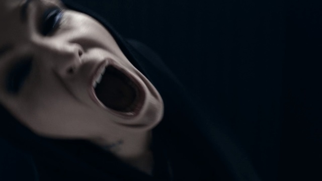 Video Reference: Face, Black, Facial expression, Nose, Head, Mouth, Shout, Chin, Lip, Darkness