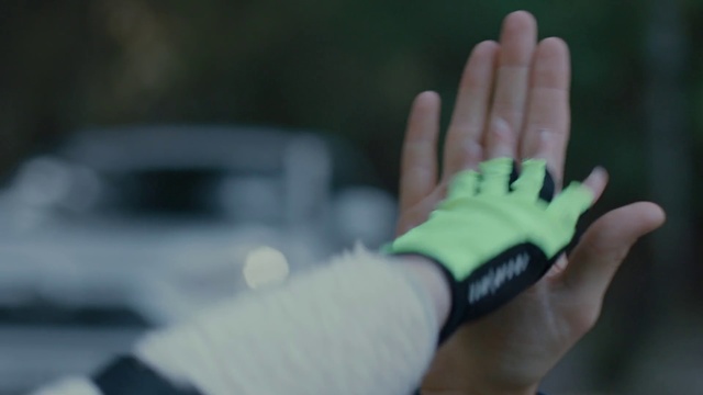 Video Reference: Green, Finger, Hand, Glove, Personal protective equipment, Thumb, Wrist, Nail, Gesture, Fashion accessory