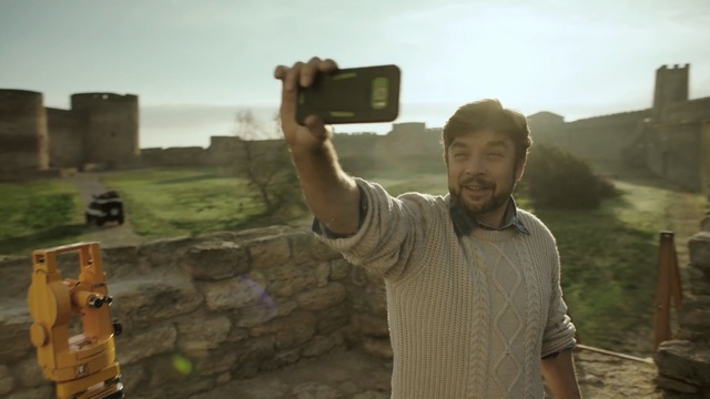 Video Reference: man, phone, hand, selfie, castle, sun, sky, Person