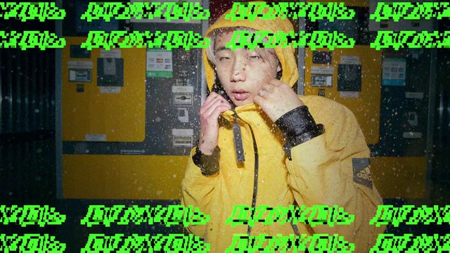 Video Reference: Photography, Photo caption, Person, Yellow, Wearing, Orange, Photo, Man, Front, Dog, Hat, Sitting, Face, Black, Standing, Store, Sign, Table, Donut, Holding, Computer, Birthday, Cake, Eating, Hot, Street, Hotdog, Train, Text, Screenshot, Poster, Human face, Cartoon, Clothing, Sale