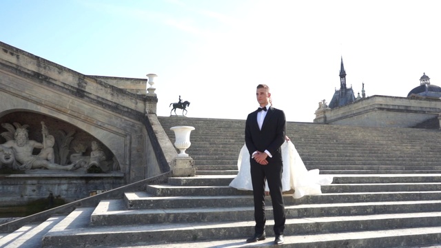Video Reference: Photograph, Suit, Snapshot, Fashion, Standing, Formal wear, Outerwear, Photography, Tuxedo, Architecture