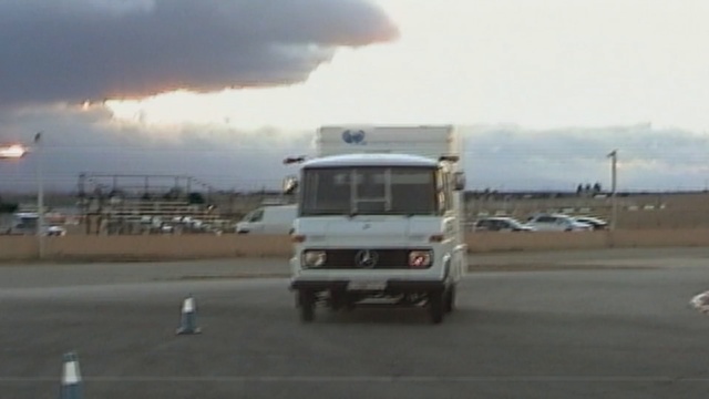 Video Reference: transport, vehicle, car, motor vehicle, commercial vehicle, mode of transport, truck, asphalt, road, automotive exterior, Person