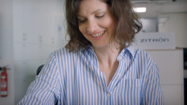 Video Reference: Hair, Chin, Lip, Smile, Mouth, Long hair, White-collar worker, Neck, Jaw, Brown hair, Person