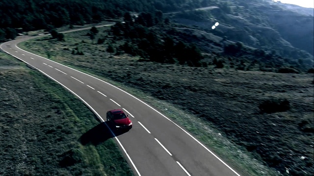 Video Reference: road, car, highway, asphalt, mountain pass, infrastructure, mountainous landforms, sky, mode of transport, lane