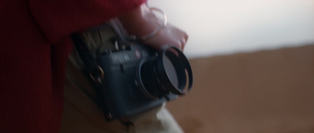 Video Reference: Camera, Cameras & optics, Camera lens, Camera accessory, Single-lens reflex camera, Lens, Reflex camera, Digital camera, Digital slr, Mirrorless interchangeable-lens camera, Indoor, Person, Sitting, Looking, Holding, Small, Table, Man, Video, Game, Playing, Red, White, Room, Standing, Remote, Young, Cake, Tripod, Cat, Plate, Optical instrument, Headphones, Point-and-shoot camera, Film camera, Teleconverter, Lens hood