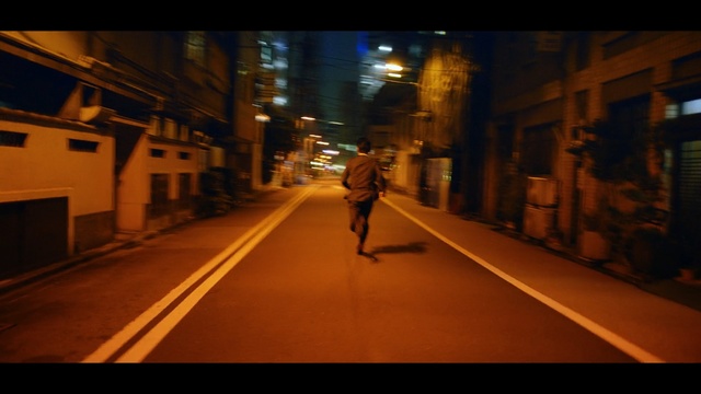 Video Reference: night, yellow, urban area, lane, infrastructure, street, light, darkness, road, snapshot, Person