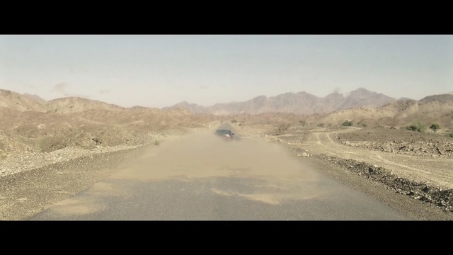 Video Reference: Road, Sky, Mode of transport, Road trip, Atmospheric phenomenon, Wadi, Infrastructure, Landscape, Ecoregion, Thoroughfare