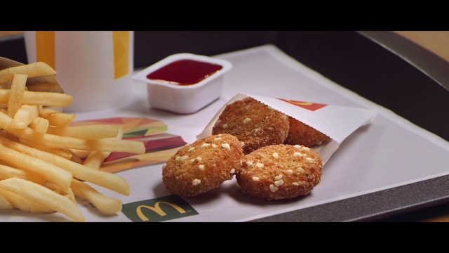 Video Reference: Dish, Food, Cuisine, Ingredient, Junk food, Fast food, Chicken nugget, Finger food, Fried food, Comfort food, Table, Indoor, Plate, Fries, Photo, Sitting, Tray, Topped, Different, Fruit, White, Sandwich, Baked goods, Dessert, Chocolate, Snack, Cake, Delicious, Bread, Croquette, Recipe, Arancini, Sata andagi, Cookie, Chicken balls, Korokke, Muffin, Bakery, Tasty, Breakfast, Sweet, Doughnut, Hushpuppy, Fritter, Pastry, Falafel, Deep frying