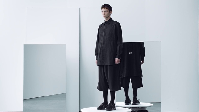 Video Reference: Clothing, Standing, Outerwear, Neck, Suit, Formal wear, Sleeve, Furniture, Fashion design