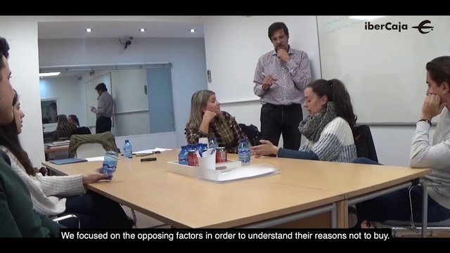 Video Reference: Event, Office, Collaboration, Job, Room, Conversation, Training, Meeting, Learning, Service, Indoor, Person, Table, People, Man, Woman, Sitting, Group, Looking, Standing, Couple, Holding, Laptop, Counter, Talking, Kitchen, Wine, Desk, Computer, Wall, Clothing, Human face, Office building, Text, Furniture