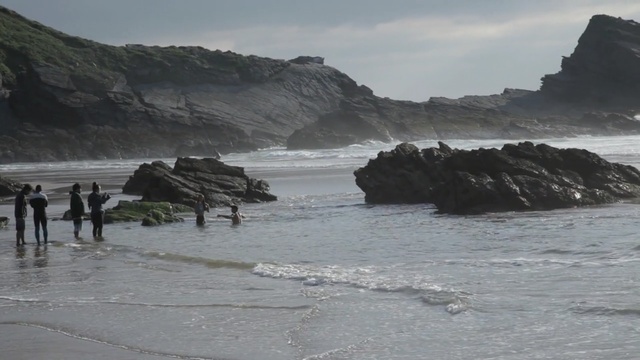 Video Reference: coast, body of water, coastal and oceanic landforms, shore, sea, headland, promontory, ocean, beach, rock, Person