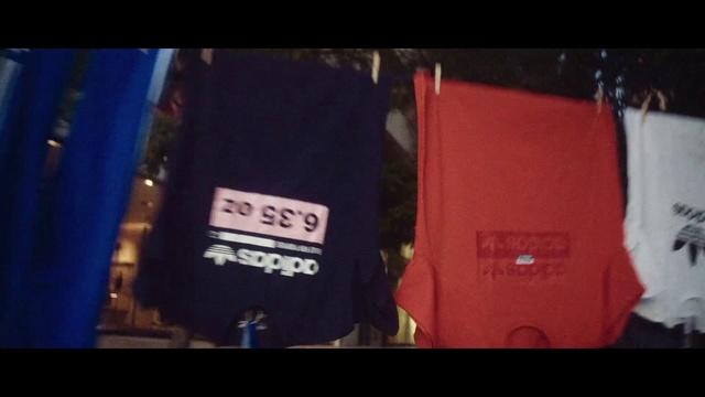 Video Reference: Red, T-shirt, Blue, Electric blue, Fashion, Jacket, Font, Personal protective equipment, Textile, Photography
