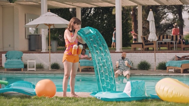 Video Reference: Aqua, Fun, Leisure, Games, Recreation, Inflatable, Backyard, Play, Vacation, Swimming pool, Building, Outdoor, Woman, Girl, Grass, Young, Lady, Table, Playing, Umbrella, Front, Green, Orange, Standing, Female, Riding, Pool, Water, Holding, Ball, Frisbee, Blue, Court, Jumping, Large, Surfing, White, Beach, Game, Soccer, Board, Man, Doing, Swimming, Person, Clothing, Playground, Swimwear, Toddler