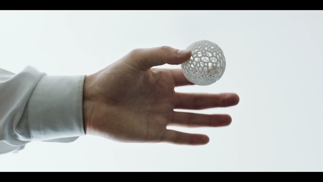 Video Reference: Hand, Finger, Arm, Golf ball, Sphere, Thumb, Glass, Stock photography, Gesture, Golf equipment