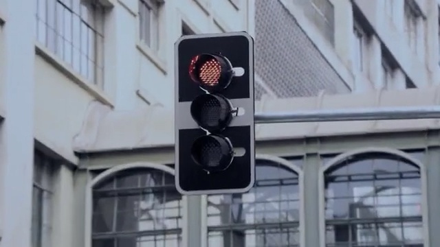 Video Reference: traffic light, signaling device, light fixture, building, facade