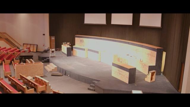 Video Reference: furniture, room, table, wall, home, interior design, design, floor, wood, angle, Person