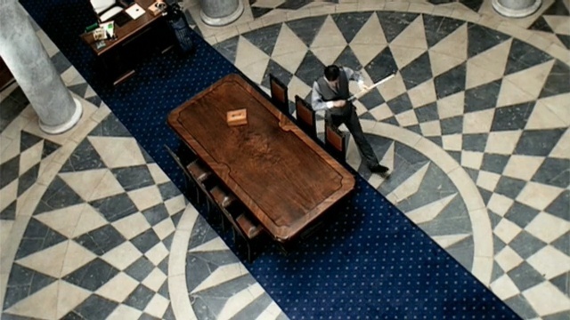 Video Reference: floor, flooring, tile, table, furniture, pattern, angle, Person