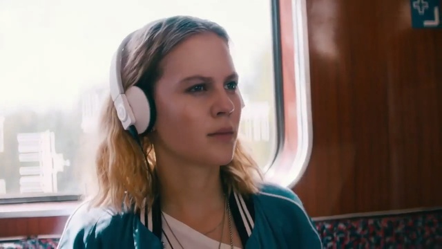 Video Reference: Hair, Face, Audio equipment, Hairstyle, Ear, Head, Eyebrow, Cheek, Chin, Blond, Person