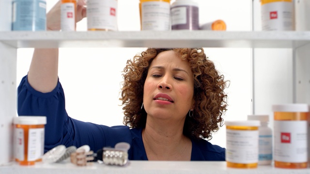 Video Reference: Product, Medicine, Prescription drug, Skin, Pharmacy technician, Pill, Pharmaceutical drug, Pharmacy, Water, Health care, Indoor, Person, Bottle, Food, Refrigerator, Table, Holding, Kitchen, Man, Woman, Sitting, Counter, Standing, White, Young, Plate, Human face, Clothing, Text, Fashion accessory, Smile