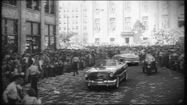 Video Reference: car, motor vehicle, photograph, black and white, monochrome photography, vehicle, mode of transport, street, crowd, family car, Person