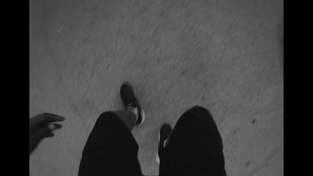 Video Reference: Black, Gesture, Grey, Black-and-white, Tints and shades, Font, Asphalt, Monochrome photography, Human leg, Monochrome