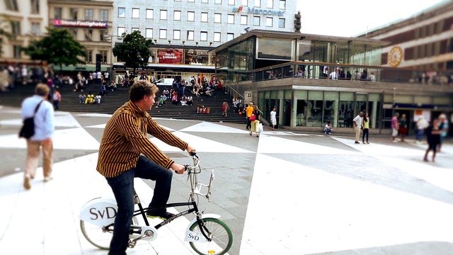 Video Reference: Bicycle, Vehicle, Cycling, Urban area, Snapshot, Mode of transport, Street, Recreation, Sports equipment, Architecture