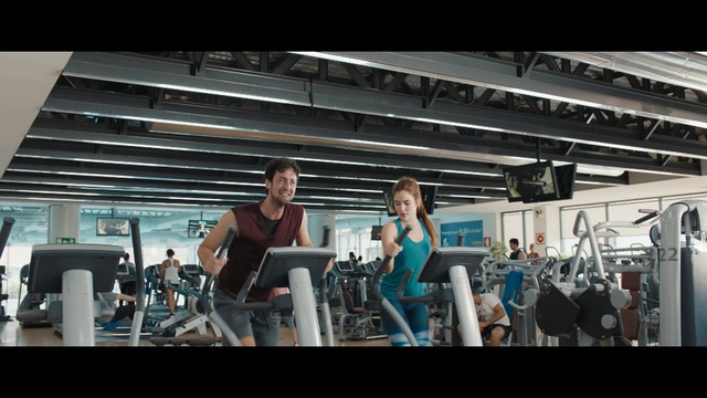 Video Reference: Gym, Shoulder, Physical fitness, Sport venue, Arm, Room, Muscle, Treadmill, Bodybuilding, Weight training, Man, Woman, Standing, Front, Table, People, Young, Holding, Group, Doing, Board, Air, Playing, Court, Kitchen, White, Person, Clothing, Computer, Laptop