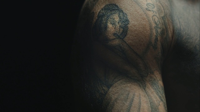 Video Reference: close up, darkness, eye, arm, human, hand, chest, tattoo, facial hair, flesh