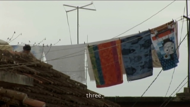 Video Reference: Wall, Roof, Town, Urban area, Flag, Architecture, Neighbourhood, Photography, Wind, Residential area, Person