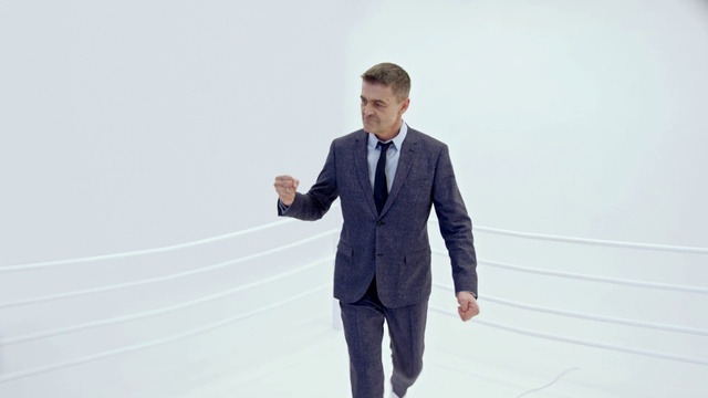 Video Reference: Suit, White, Standing, Formal wear, Businessperson, White-collar worker, Tuxedo, Tie, Photography, Business