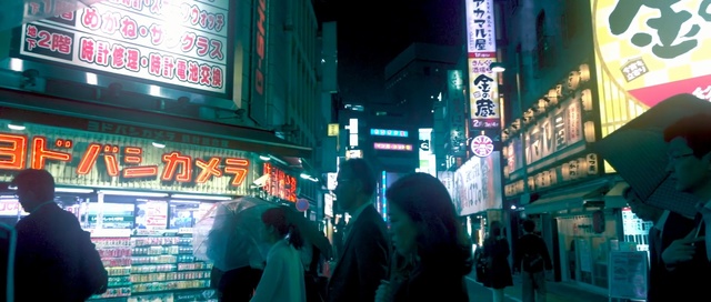 Video Reference: snapshot, technology, city, electronic device, metropolitan area, neon, street, night, metropolis, market, Person