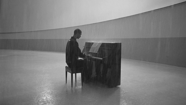 Video Reference: Musical instrument, Piano, Keyboard, Musician, Pianist, Standing, Black-and-white, Grey, Style, Art